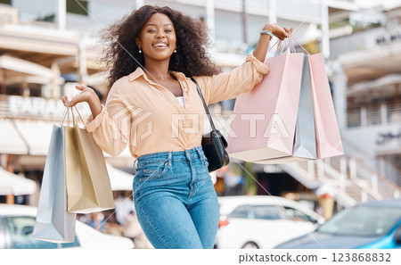 Shopping, fashion and retail, a black woman with smile and designer boutique shopping bags outside a mall. Happy customer or influencer after discount sale in city shopping mall parking lot or street 123868832