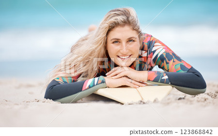 Surf, sports and beach portrait of woman relax on sand before ocean sea fitness, training exercise or wellness workout. Happy, smile and surfer girl ready for waves surfing freedom or water adventure Surf, sports and beach portrait of woman relax on sand before ocean sea fitness, training exercise or wellness workout. Happy, smile and surfer girl ready for waves surfing freedom or water adventure 123868842