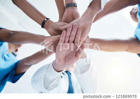 Below, group and hands stack for medical, staff and teamwork in hospital for motivation. Team, doctor and nurse with hand for collaboration, healthcare and help in community at job together in clinic Below, group and hands stack for medical, staff and teamwork in hospital for motivation. Team, doctor and nurse with hand for collaboration, healthcare and help in community at job together in clinic 123869078
