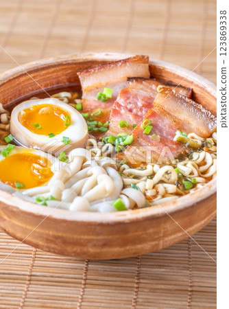 Hearty rustic ramen bowl with pork belly, beech mushrooms, and ramen eggs Hearty rustic ramen bowl with pork belly, beech mushrooms, and ramen eggs 123869338