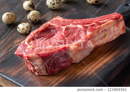 Raw Cowboy Steak with Marbling on Wooden Board, Ready to Cook 123869361