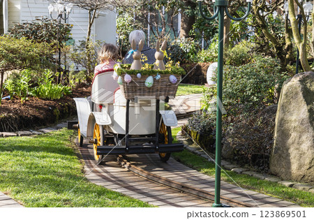 Attraction for children, car in an amusement park decorated with Easter eggs and bunnies. 123869501