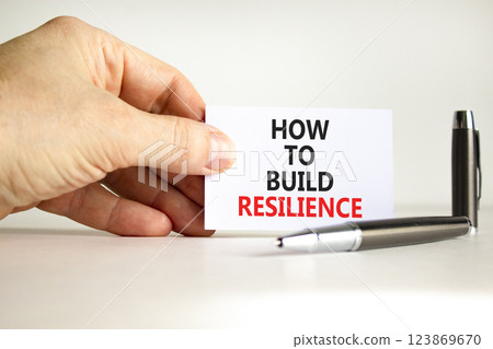 How to build resilience symbol. Concept words How to build resilience on beautiful white paper. Beautiful white background. Businessman hand. Business and how to build resilience concept. Copy space How to build resilience symbol. Concept words How to build resilience on beautiful white paper. Beautiful white background. Businessman hand. Business and how to build resilience concept. Copy space 123869670
