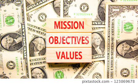Mission objectives values symbol. Concept words Mission Objectives Values on beautiful blocks. Dollar bills. Beautiful dollar bills background. Business mission objectives values concept. Copy space. Mission objectives values symbol. Concept words Mission Objectives Values on beautiful blocks. Dollar bills. Beautiful dollar bills background. Business mission objectives values concept. Copy space. 123869678