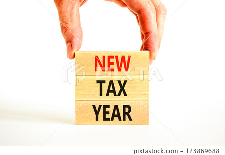 New tax year symbol. Concept words New tax year on beautiful wooden blocks. Beautiful white background. Businessman hand. Business new tax year concept. Copy space. New tax year symbol. Concept words New tax year on beautiful wooden blocks. Beautiful white background. Businessman hand. Business new tax year concept. Copy space. 123869688