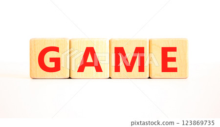 Game symbol. Concept word Game on beautiful wooden blocks. Beautiful white table white background. Business, lifestyle and game concept. Copy space. Game symbol. Concept word Game on beautiful wooden blocks. Beautiful white table white background. Business, lifestyle and game concept. Copy space. 123869735