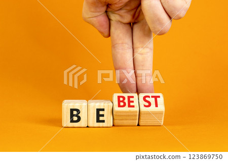 Motivational and inspirational be best symbol. Concept words Be best on beautiful wooden block. Beautiful orange background Businessman hand. Business motivational be best concept. Copy space. 123869750
