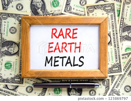 Rare earth metals symbol. Concept words Rare earth metals on beautiful wooden picture frame. Black pen. Beautiful background from dollar bills. Business and rare earth metals concept. Copy space. 123869797