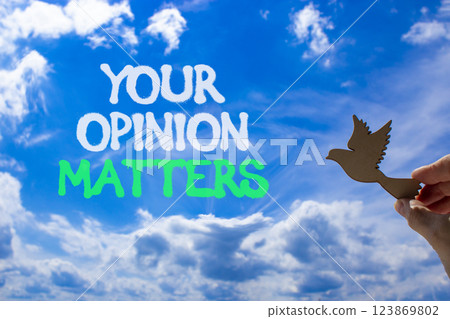 Your opinion matters symbol. Concept words Your opinion matters on beautiful blue sky. Beautiful blue sky and clouds background. Businessman hand. Business your opinion matters concept. Copy space. Your opinion matters symbol. Concept words Your opinion matters on beautiful blue sky. Beautiful blue sky and clouds background. Businessman hand. Business your opinion matters concept. Copy space. 123869802