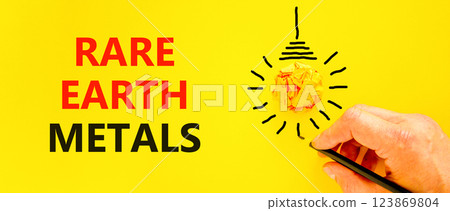 Rare earth metals symbol. Concept words Rare earth metals on beautiful yellow paper. Beautiful yellow background. Businessman hand with pen. Business and rare earth metals concept. Copy space. Rare earth metals symbol. Concept words Rare earth metals on beautiful yellow paper. Beautiful yellow background. Businessman hand with pen. Business and rare earth metals concept. Copy space. 123869804