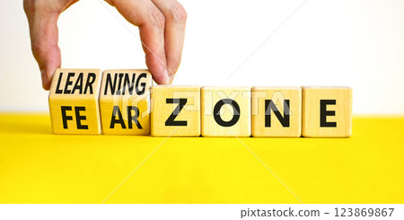 Learning or fear zone symbol. Concept words Learning zone Fear zone on wooden cubes. Beautiful yellow table white background. Psychologist hand. Business and learning or fear zone concept. Copy space. Learning or fear zone symbol. Concept words Learning zone Fear zone on wooden cubes. Beautiful yellow table white background. Psychologist hand. Business and learning or fear zone concept. Copy space. 123869867
