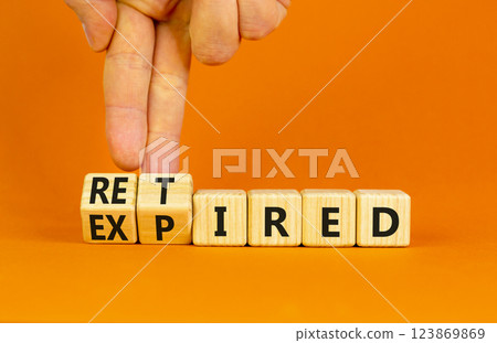 Retired or expired symbol. Concept words Retired Expired on wooden cubes. Beautiful orange table orange background. Businessman hand. Business and retired or expired concept. Copy space. 123869869