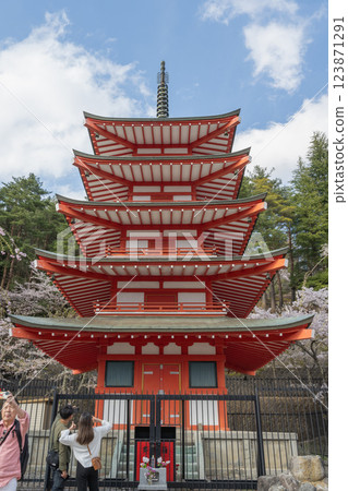 Fujiyoshida City, Yamanashi District, Japan - April 17, 2024: Arakura Fuji Asama Shrine. Spring: The red pagoda of Mt. Fuji and cherry blossoms in full bloom. Fujiyoshida City, Yamanashi District, Japan - April 17, 2024: Arakura Fuji Asama Shrine. Spring: The red pagoda of Mt. Fuji and cherry blossoms in full bloom. 123871291