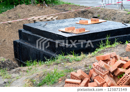 Construction Site Showing Foundation Blocks and Bricks Prepared for Building in a Rural Area During Daytime 123871549