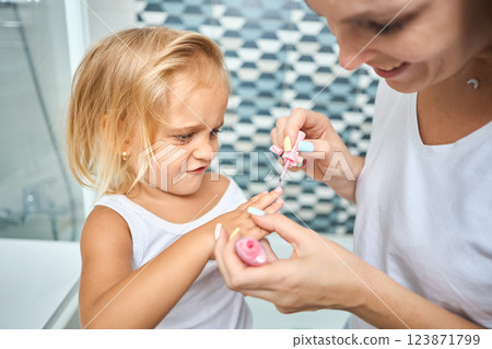 Young mother and daughter in curlers in a bathroom 123871799
