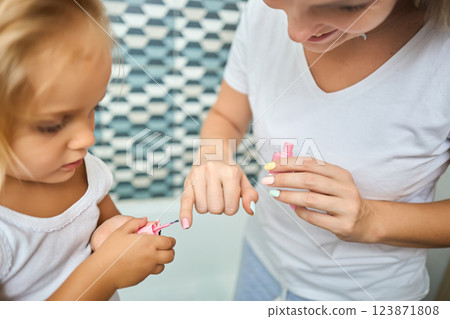 Young mother and daughter in curlers in a bathroom 123871808