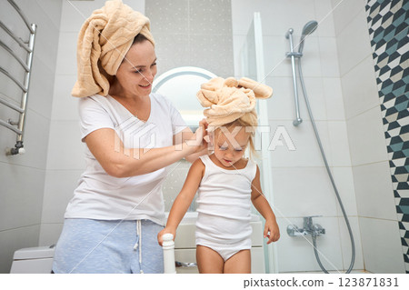 Mother of a child daughter with a towel dry hair 123871831
