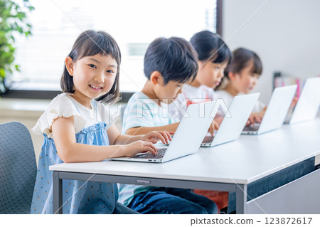 Children learning on a computer 123872617