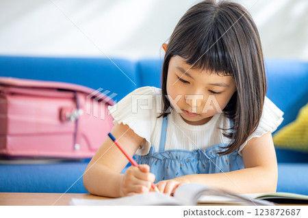 A girl studying in the living room A girl studying in the living room 123872687