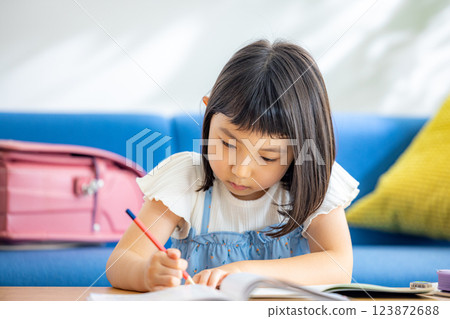 A girl studying in the living room A girl studying in the living room 123872688