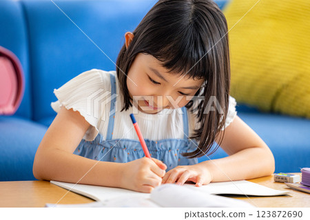 A girl studying in the living room A girl studying in the living room 123872690