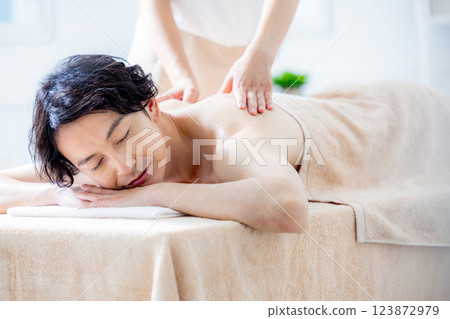 A young man receiving a massage at a beauty salon 123872979