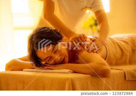 A young man receiving a massage at a beauty salon 123872984