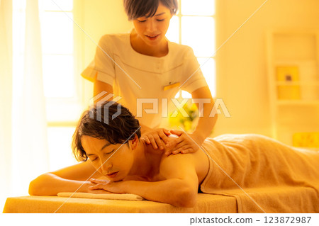 A young man receiving a massage at a beauty salon A young man receiving a massage at a beauty salon 123872987