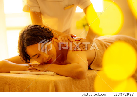 A young man receiving a massage at a beauty salon 123872988