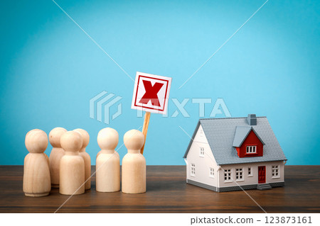 Protest against construction. Crowd of miniature people and house model on wooden table 123873161