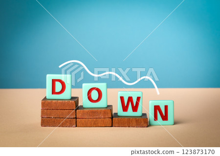 Down. Alphabet blocks on wooden blocks. Light background Down. Alphabet blocks on wooden blocks. Light background 123873170