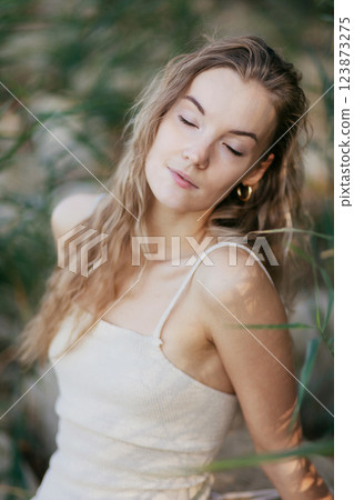 Blonde caucasian woman with pure clean skin, enjoy summer with closed eyes, natural beauty 123873275
