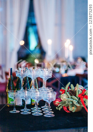 A pyramid of wide champagne glasses on deep blue tablecloth at event A pyramid of wide champagne glasses on deep blue tablecloth at event 123873293