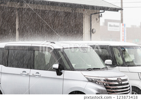 Heavy rain hitting the roof of a car 123873418