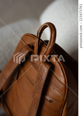 photo of a orange leather backpack with retro look. indoors photo 123873761