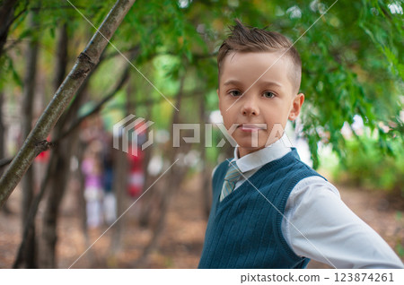 Young Pupil Boy Holding a Bouquet for Celebration Young Pupil Boy Holding a Bouquet for Celebration 123874261