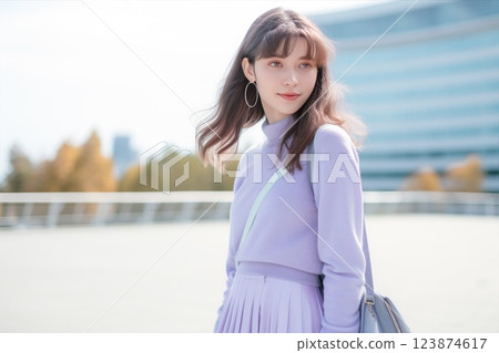Asian girl is wearing a light violet sweater with a matching skirt, accompanied by a backpack. Her hair flows down, and she exudes a fashionable sense of style. Fashion teenage model. Teen lavender 123874617