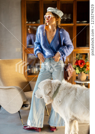 Stylish Woman with a Dog in a Cozy Interior Stylish Woman with a Dog in a Cozy Interior 123874929