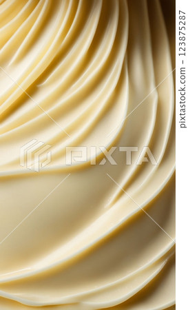 Close-up of smooth butter spread with creamy texture and golden color. Abstract food background and dairy product concept 123875287