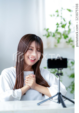 Smiling woman taking a video 123875508