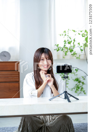 Smiling woman taking a video 123875509