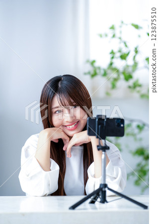 Smiling woman taking a video 123875510