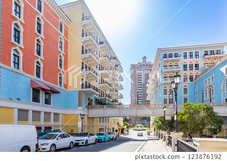 Qanat Quartier Venetian copy luxury residential district with authentic colorful apartment buildings and road with cars in the foreground, Pearl Island, Doha, Qatar 123876192