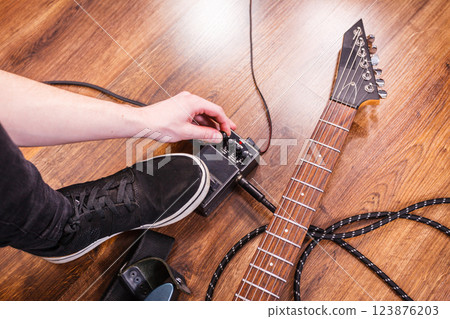 Man setting up guitar equipment 123876203