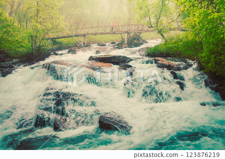 Tourist on river bridge, Norway 123876219