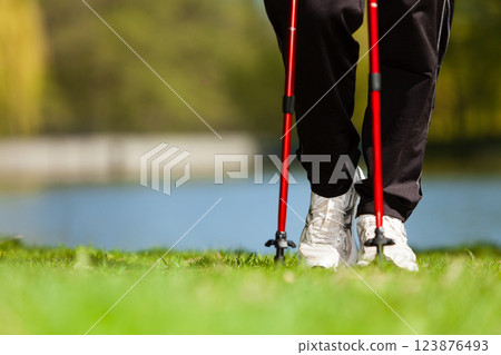 Nordic walking. Female legs hiking in the park. 123876493