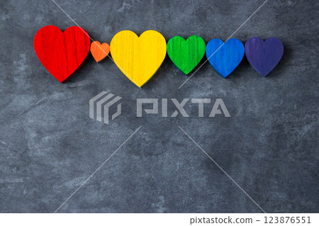 Rainbow colors wood hearts on the stone black background. Lgbt flag. Rainbow colors wood hearts on the stone black background. Lgbt flag. 123876551