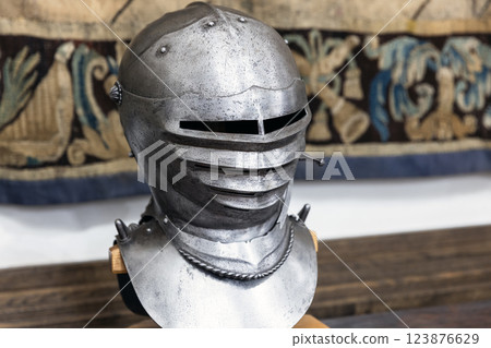 Iron forged medieval helmet displayed on a stand, 123876629