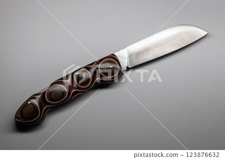 Custom knife featuring a refined blade and artistic handle design, 123876632