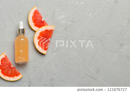 Bottles with Grapefruit fruit essential oil on wooden background. alternative medicine top view with copy space 123876727